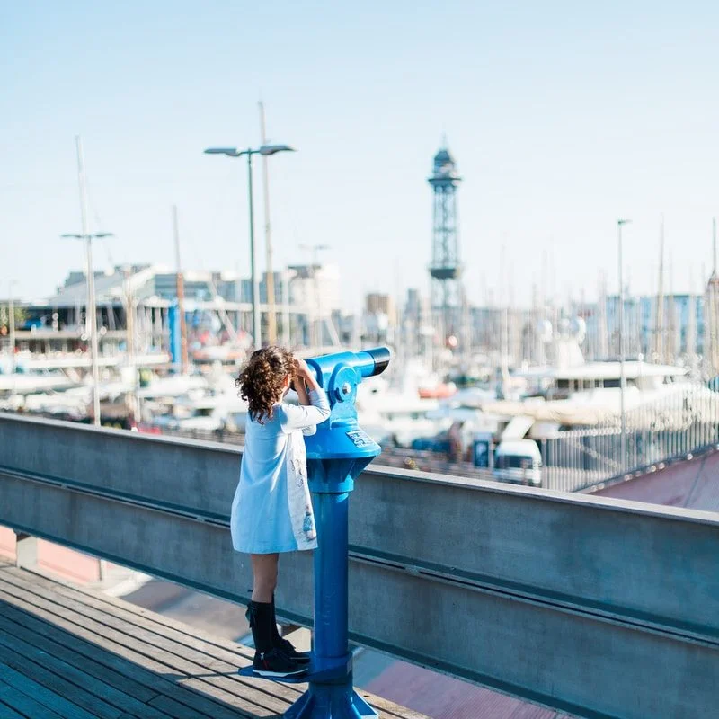 photography of girl using tower viewer