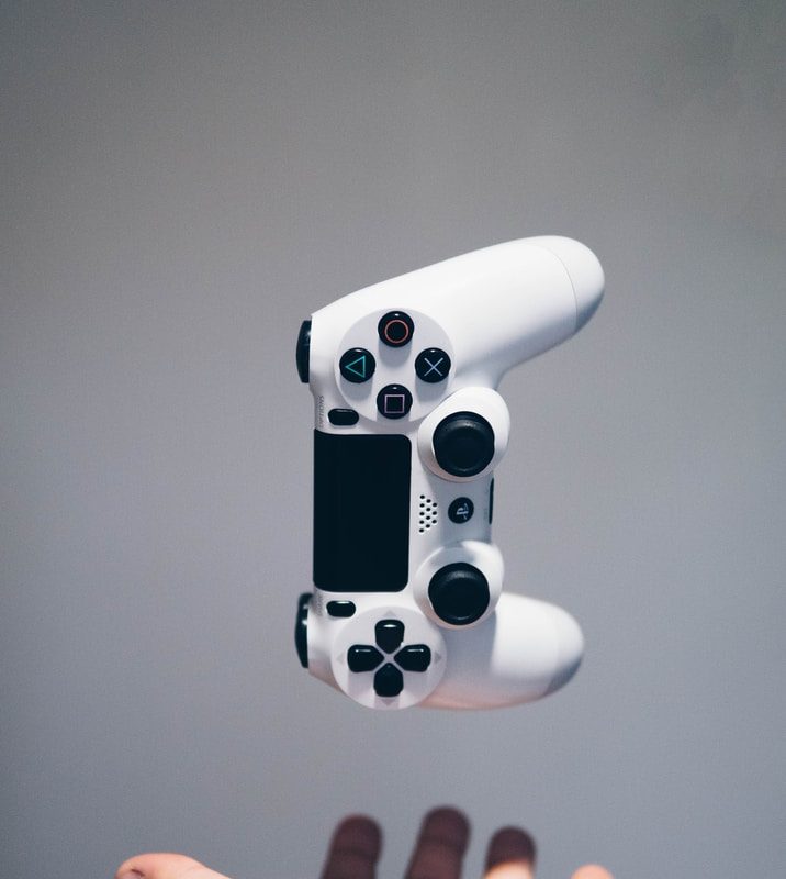 white Sony PS4 DualShock controller over person's palm