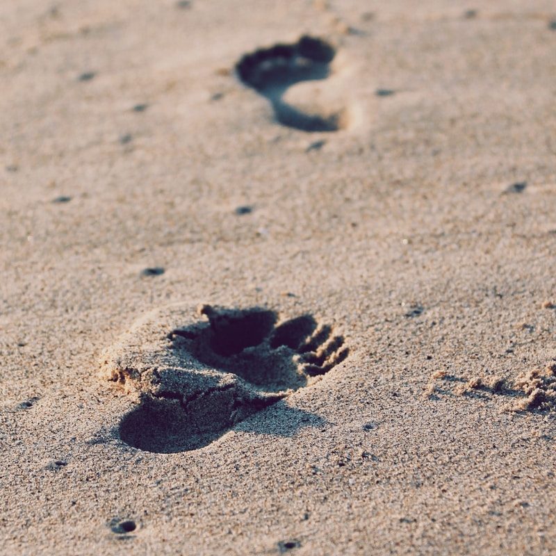 foot prints on beach sand
