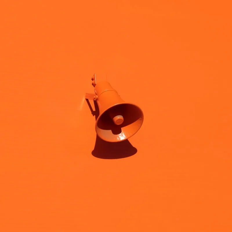 orange megaphone on orange wall