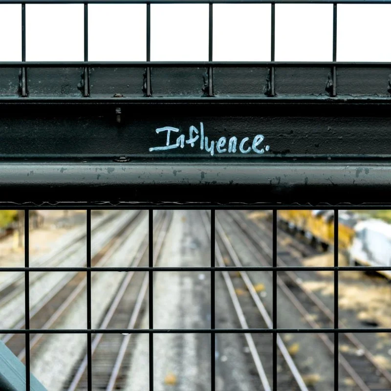 influence painted black metal frame during daytime