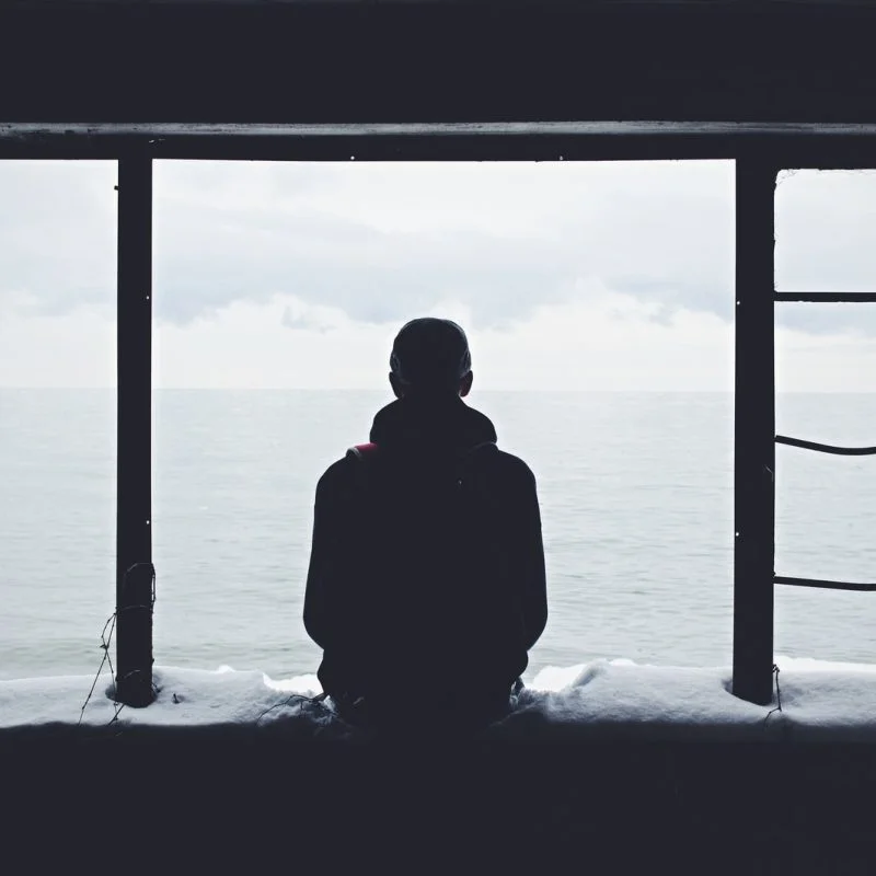 person looking out through window