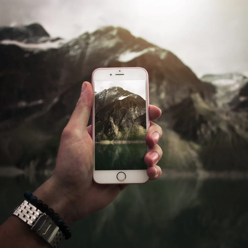person taking photo on mountain