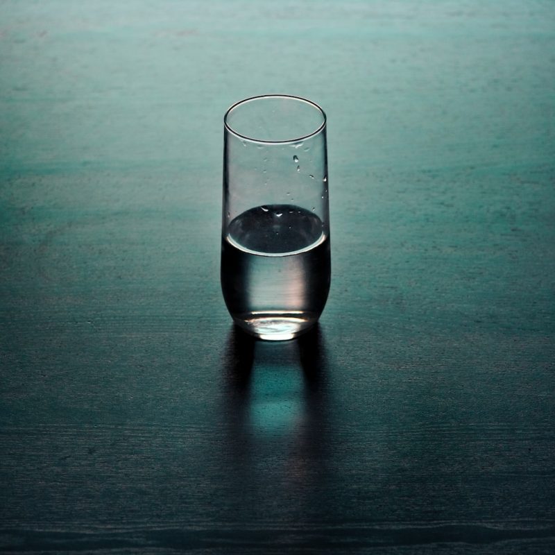 clear drinking glass on brown wooden surface