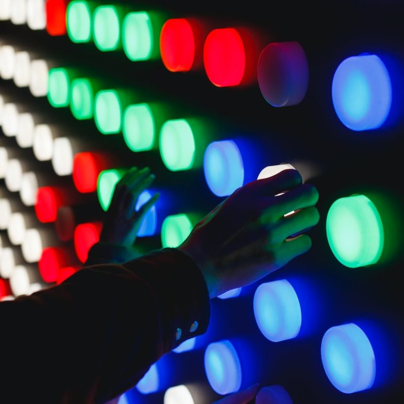 people holding assorted-color LED lights