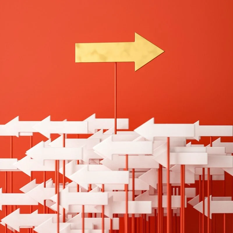 a red wall with a yellow arrow pointing in opposite directions