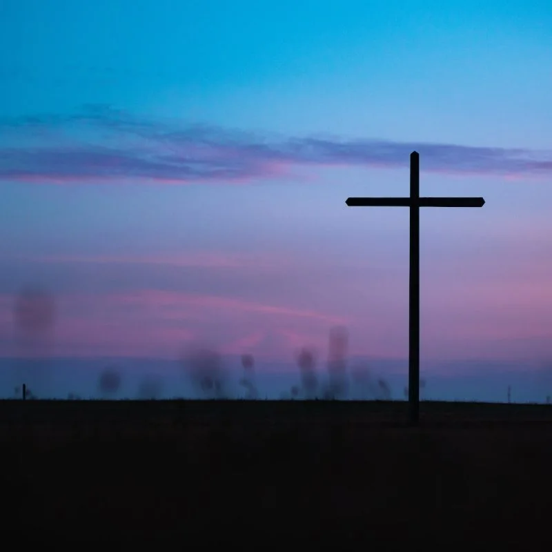 cross stand under purple and blue sky