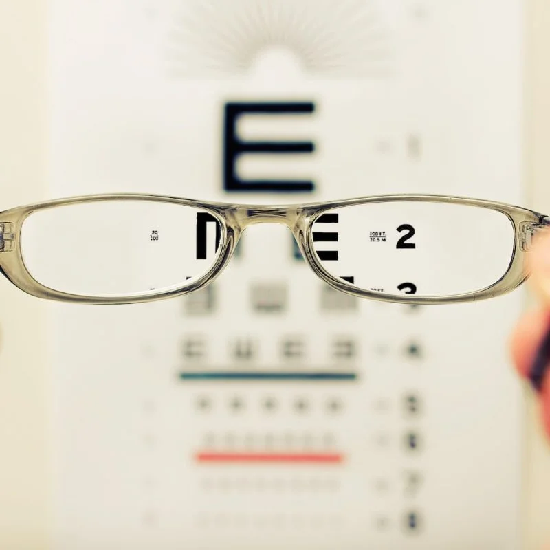 person holding eyeglasses