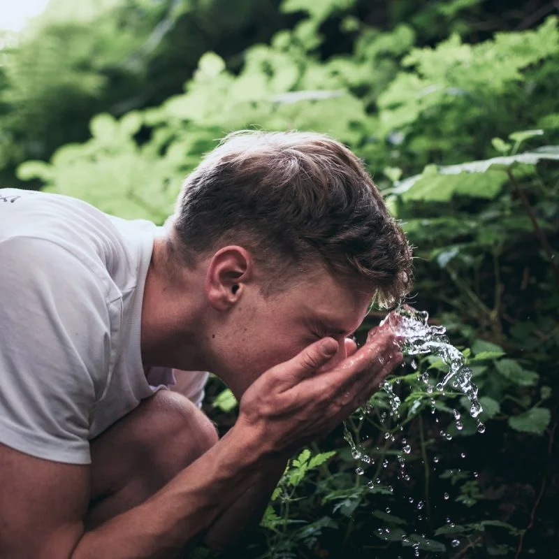 man washing his face