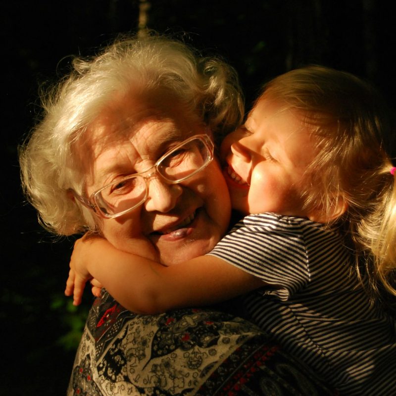 woman in black and white striped shirt hugging girl in black and white striped shirt