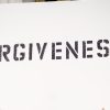 person holding Forgiveness poster