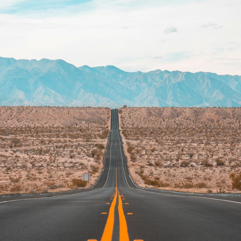 long exposure photography of black concrete road on open area during daytime